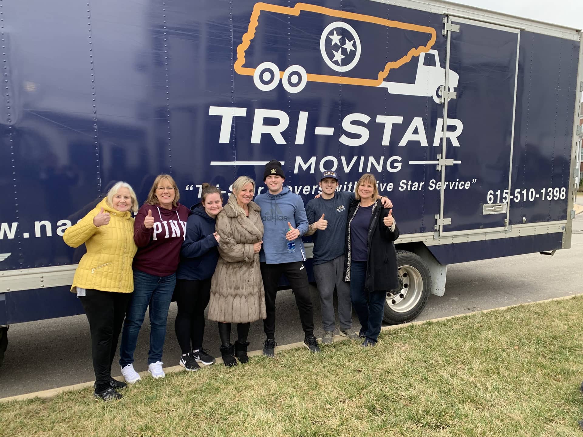 Staff and client photo in front of Tri-Star Moving truck