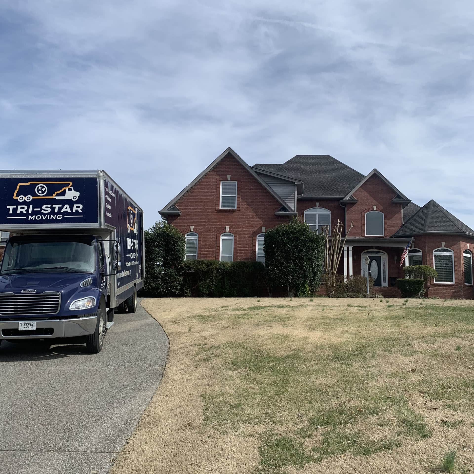 Ouside shot of home with Tri-Star Moving truck