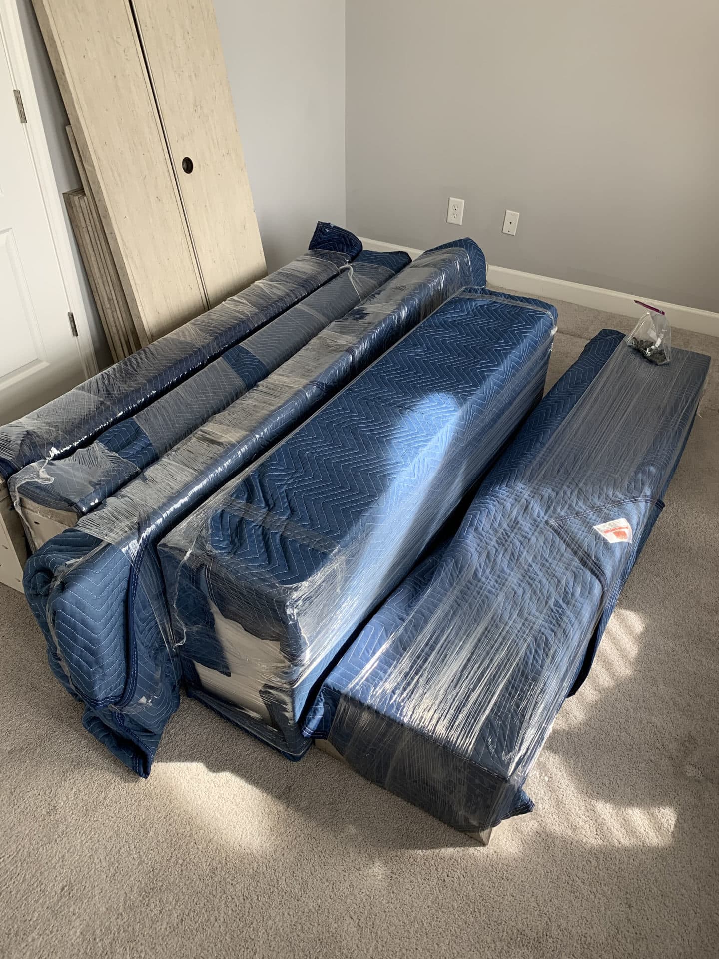 Multiple pieces of furniture wrapped for a move
