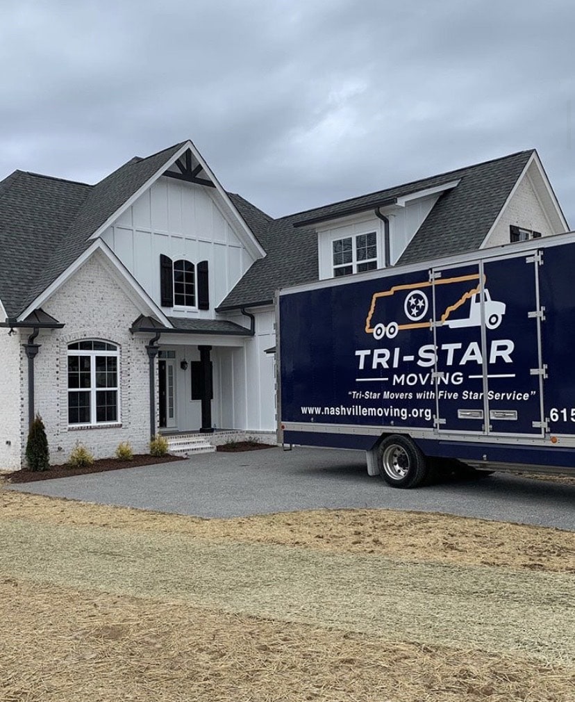 Tri-Star Moving truck backed in front of house