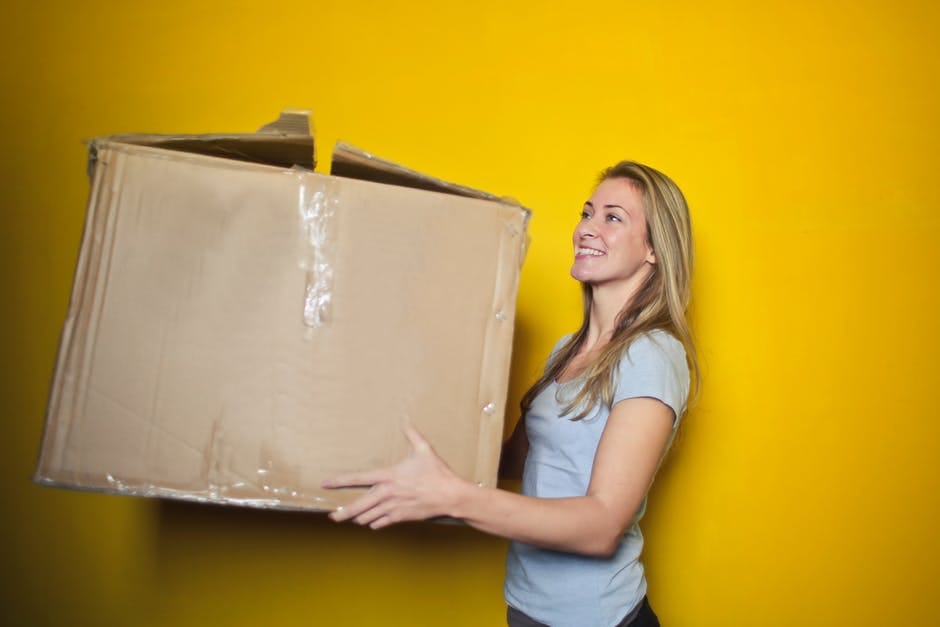 Woman carrying box to move